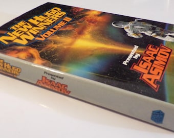 May include: A book titled "The New Hugo Winners Volume II" presented by Isaac Asimov. The cover features a futuristic scene with a person in a spacesuit.