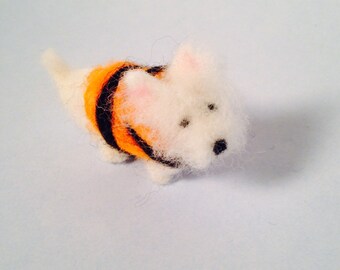 Miniature westie figurine wearing a life jacket