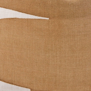 May include: Close-up of a tan fabric with a woven texture. A white, angular shape is visible in the upper left corner. The fabric has a slightly rough appearance, suggesting a natural material like linen or cotton.