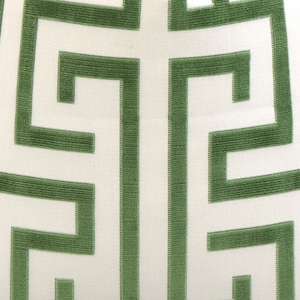 May include: A white fabric with a green geometric pattern. The pattern is a repeating design of interlocking squares and rectangles.