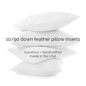 May include: A stack of four white down feather pillow inserts. 10/90 down feather pillow inserts. luxurious + handcrafted made in the USA