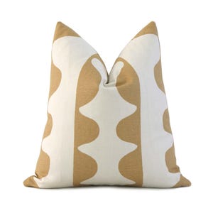May include: A white throw pillow with a brown geometric pattern. The pattern features a series of rounded, wavy shapes.