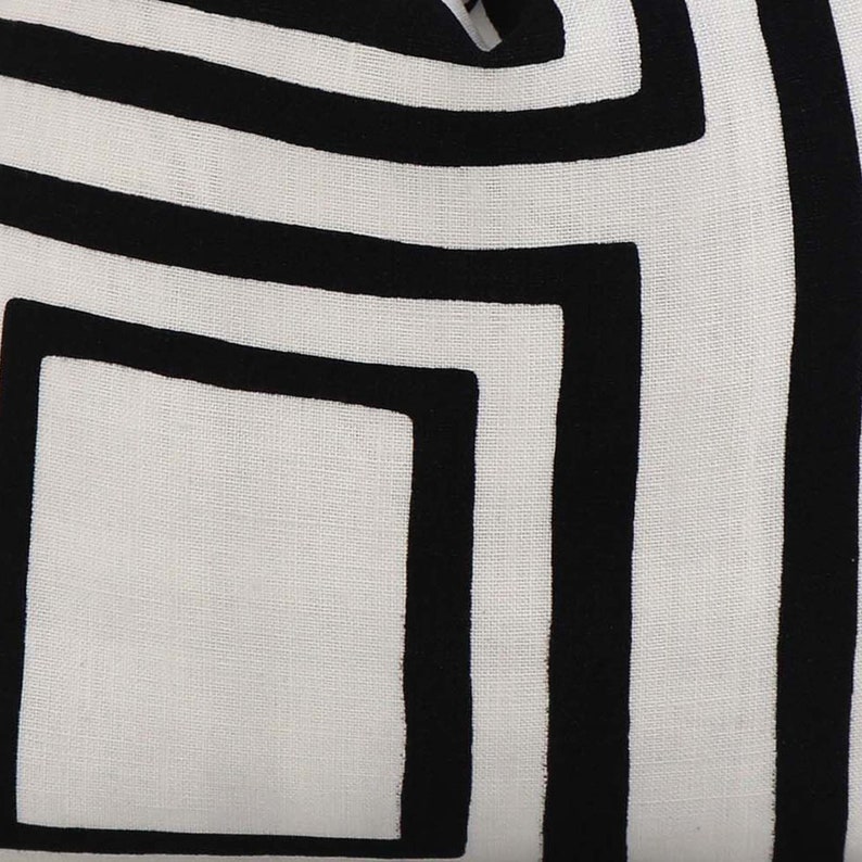 May include: White fabric with a black geometric pattern of overlapping squares. The pattern is created with thick black lines.
