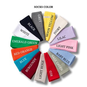 May include: A circular arrangement of ribbed socks in various colors labeled SOCKS COLOR. The colors include black, grey, moon yellow, ivory, lilac, light pink, baby blue, sage green, red, light beige, burgundy, blue, red orange, emerald green, and white.
