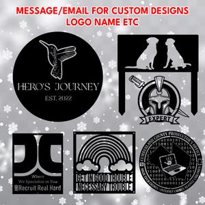 May include: A collection of black metal signs with various designs. One features a hummingbird, another two dog silhouettes, and a third a spartan helmet. Other signs include text: "HERO'S JOURNEY", "EXPERT", "GET IN GOOD TROUBLE NECESSARY TROUBLE".