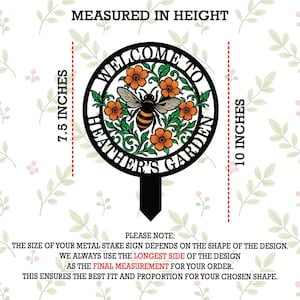 May include: A circular black metal garden stake sign featuring a bee and orange flowers with green leaves. The text reads WELCOME TO HEATHER'S GARDEN. The sign is shown with height measurements of 7.5 inches and 10 inches indicated on the sides.