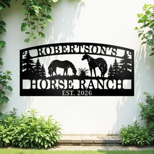May include: Black metal sign with the text "ROBERTSON'S HORSE RANCH EST. 2026". The sign features silhouettes of two horses, trees, and decorative elements, suitable for outdoor display.