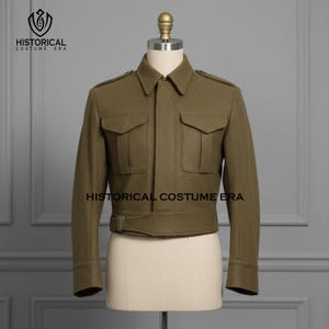 May include: Olive green jacket with two chest pockets and a belted waist. The jacket has long sleeves and a collar. The text "HISTORICAL COSTUME ERA" is printed on the jacket. The jacket is displayed on a mannequin.
