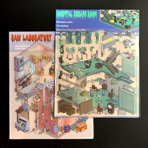 May include: Two miniature scene kits, "Saw Laboratory" and "Hospital Escape Room," are displayed. The "Saw Laboratory" kit features a detailed, illustrated interior with gears and machinery. The "Hospital Escape Room" kit shows a multi-level hospital scene with various objects.
