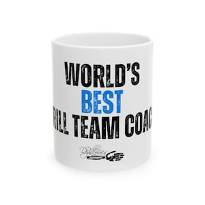 May include: White ceramic mug with the text "WORLD'S BEST DRILL TEAM COACH" in black and blue lettering. The mug also features a small logo at the bottom. The mug is a standard size and shape.