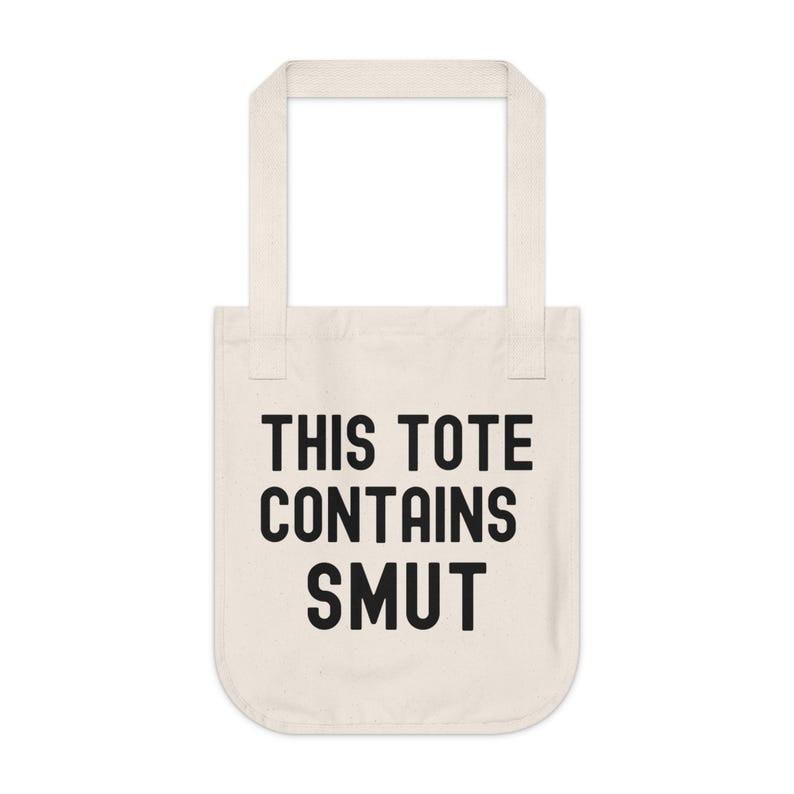 Pode incluir: Saco tote creme com o texto preto "THIS TOTE CONTAINS SMUT". O saco tem duas al&ccedil;as e &eacute; feito de um material semelhante a lona. O texto est&aacute; centrado na frente do saco.