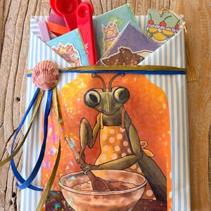 May include: A light blue and white striped paper envelope containing red measuring spoons and various illustrated cards. The front features a holographic sticker of a praying mantis wearing a polka dot apron and mixing ingredients in a bowl.