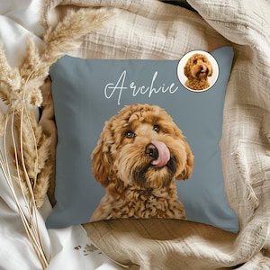 May include: A square, slate blue decorative pillow featuring a detailed illustration of a golden doodle dog with its tongue out. The name "Archie" is written in cursive script across the top. A smaller image of the dog is in the upper right corner.