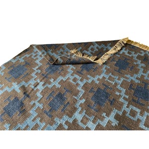 Handwoven wool kilim rug in brown and blue geometric tribal pattern; flatweave, boho living room or bedroom rug.