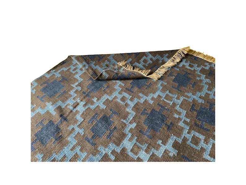Handwoven wool kilim rug in brown and blue geometric tribal pattern; flatweave, boho living room or bedroom rug.