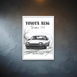 May include: Black and white framed print featuring a Toyota AE86 Trueno 1985 car drifting. The print includes the car's name and the text "LIGHTWEIGHT LEGEND DRIFT BEGINS HERE". The artwork is displayed in a garage setting.