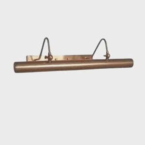 May include: A horizontal, tubular picture light fixture with a metallic bronze finish. The lamp features a rectangular mounting plate and two curved, adjustable arms that connect the base to the cylindrical light housing.