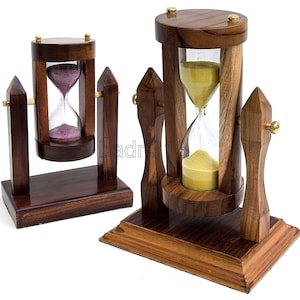 May include: Two rotating hourglasses with dark brown wooden frames and brass accents. The smaller hourglass contains purple sand, while the larger one contains yellow sand. Both are mounted on rectangular wooden bases with pointed side supports.