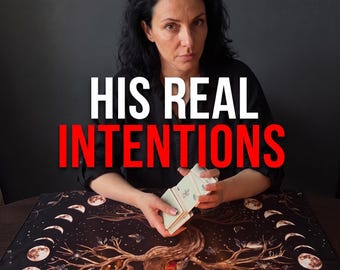 May include: A deck of tarot cards held in hands over a black cloth featuring a printed tree and moon phases. The text HIS REAL INTENTIONS is displayed in white and red letters. The cards have a light green back design with a central emblem.