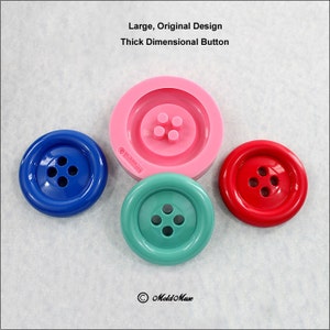 May include: A pink silicone mold for making large, thick, four-hole buttons. Three buttons are shown in the image: blue, green, and red.