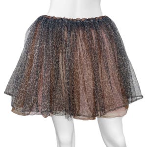 May include: A short, layered skirt with a leopard print pattern. The skirt features a combination of brown, black, and tan colors. The skirt is made of a sheer, lightweight material, and has an elastic waistband.