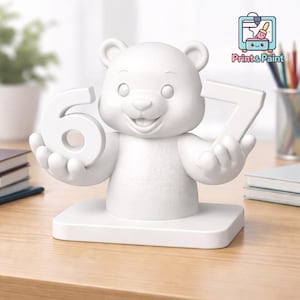 May include: A white bear figurine holding the numbers 6 and 7. The bear is smiling and stands on a rectangular base. The image includes the text "Print & Paint".