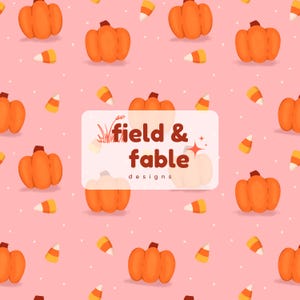 May include: A repeating pattern of orange pumpkins and candy corn on a pink background with white polka dots. The design includes the text "field & fable designs" in a white rectangle.
