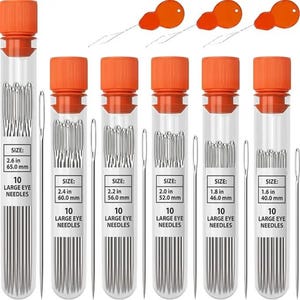 May include: Six clear plastic tubes with orange screw caps, each containing ten silver metal large eye needles. Labels indicate sizes ranging from 1.6 inches to 2.6 inches. Three orange needle threaders are positioned at the top of the image.