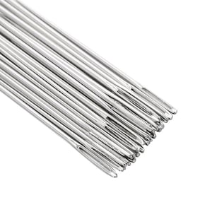 May include: A close-up shot of a collection of silver sewing needles. Each needle is slender, featuring a small eye at one end and a sharp point at the other. The needles are arranged diagonally against a white backdrop.