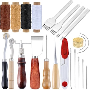 May include: A leather crafting tool kit featuring four spools of thread in brown, tan, black, and white, four metal stitching chisels, a tracing wheel, a groover, a skiving tool, awls, a red thread cutter, needles, and a gold-tone thimble.