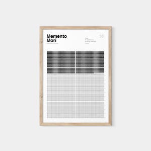 May include: A framed print with the words "Memento Mori" and a quote about life. The print features a grid design with black and gray squares. The frame is made of light-colored wood.