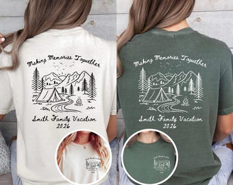 May include: A white and a dark green t-shirt, each featuring a back graphic of a mountain landscape, a tent, a campfire, and trees with the text "Making Memories Together", "Smith Family Vacation", and "2026". A small matching front pocket print.