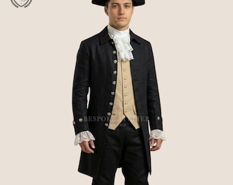 May include: A black frock coat, matching knee-length breeches, and a tan waistcoat. The ensemble includes a white lace cravat, white lace sleeve cuffs, and a black tricorn hat. The coat features silver-toned buttons down the front and on the cuffs.