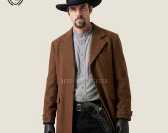 May include: A brown wool coat with a black hat and gloves. The coat has a classic design with a notched lapel and button closure. A holster with a gun is attached to the belt. The text "BESPOKE ATELIER" is visible.