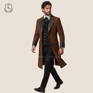 May include: A long brown overcoat with black leather detailing on the collar and cuffs. The coat is worn over a black waistcoat and trousers. The text "BESPOKE ATELIER LONDON" is visible.