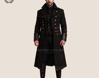 May include: A black long coat featuring a double-breasted front with metallic buttons, leather cuffs, and side buckle straps. The coat is worn over a matching vest, shirt, and trousers, paired with black leather boots. Text reads BESPOKE ATELIER LONDON.