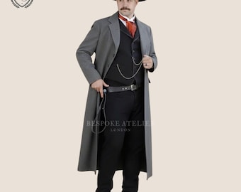 May include: A grey wool-blend long coat worn over a black vest, black trousers, and a white shirt with a red cravat. The outfit includes a black wide-brimmed hat, a silver pocket watch chain, a black leather belt, and black leather boots.
