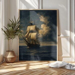 May include: A framed painting of a tall ship sailing on a dark blue sea under a cloudy sky. The ship has multiple sails and is depicted in a classic, vintage style. The artwork is displayed in a room with a potted plant and wooden flooring.