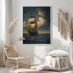 May include: A framed nautical painting depicts a tall ship sailing on a dark blue sea under a cloudy sky. The artwork features a vintage aesthetic with a white frame, suitable for home decor.
