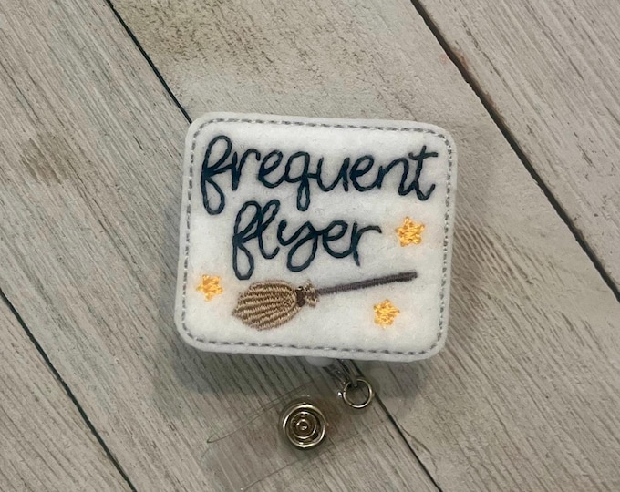 Frequent flyer badge holder, broom feltie, retractable reel, badge pull