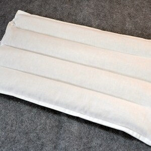 May include: White rectangular pillow with three horizontal channels, designed for comfort and support.