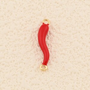 May include: A red, curved charm with gold-colored loops at each end. The charm has a smooth, glossy finish and a slight wave shape. This jewelry component is suitable for necklaces, bracelets, or earrings.