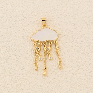 May include: A gold-colored cloud pendant with a white cloud-shaped center and dangling rain drops. The rain drops are made of gold chains with small, clear gemstones. The pendant has a small loop at the top for a chain.
