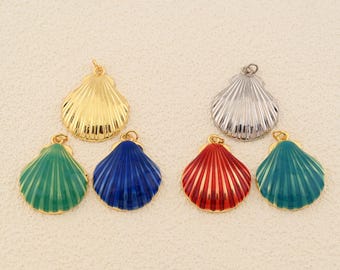 May include: A collection of seashell-shaped pendants in various colors and finishes. The pendants include gold, silver, green, blue, red, and teal. Each pendant has a textured, ridged surface and a small loop for attaching to a chain or other jewelry.