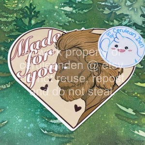May include: A heart-shaped sticker featuring a profile illustration of a person with brown hair and a beard. The text "Made for you" is printed in a stylized font on the left side, accompanied by two small dark hearts.