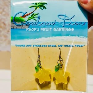 May include: A pair of Paopu Fruit Earrings, with yellow star-shaped charms and green leaf accents. The earrings are on a card with the text "Caribbean Ben" and "Hooks are stainless steel and nickel free!"