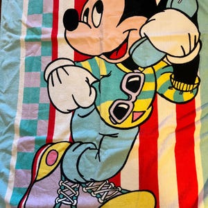 May include: A white ceramic mug with a black handle and the text "But First, Coffee" in a black, bold font. The mug is on a white surface.