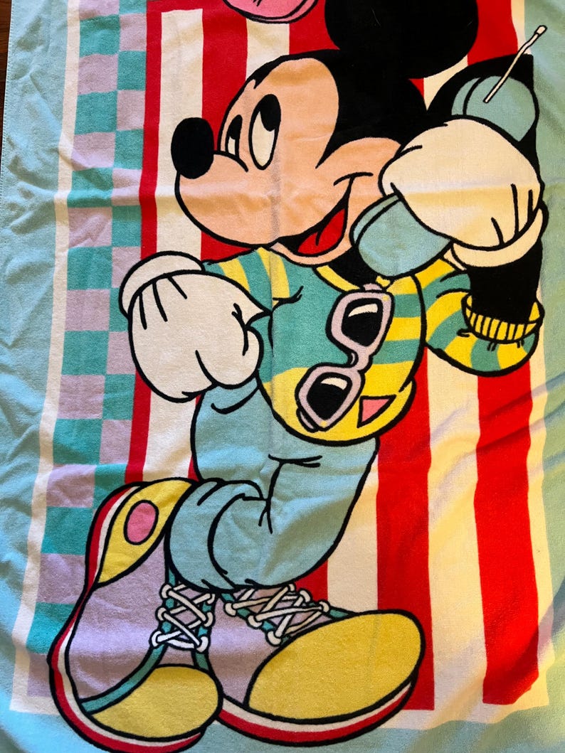 May include: A white ceramic mug with a black handle and the text "But First, Coffee" in a black, bold font. The mug is on a white surface.