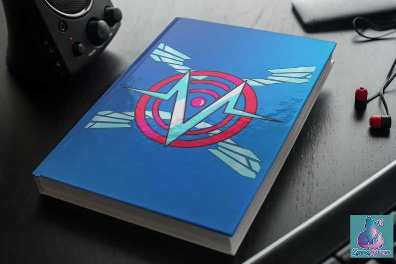 May include: A blue notebook with a graphic design on the cover. The design features a white and light blue lightning bolt shape inside a red and pink circle, with light blue wing shapes. The notebook is on a dark surface.