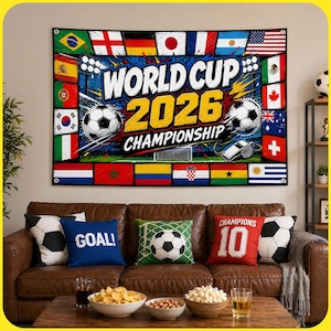 May include: A rectangular wall tapestry featuring the text WORLD CUP 2026 CHAMPIONSHIP in bold white and yellow letters. The design includes two black and white soccer balls, a whistle, and a border of various national flags on a blue background.